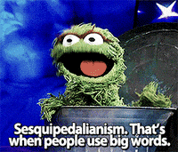 A muppet-type puppet sitting in a bin with the caption "Sesquipedalianism. That's when people use big words"