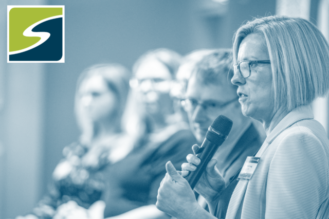 Jane Naylor speaking into a microphone